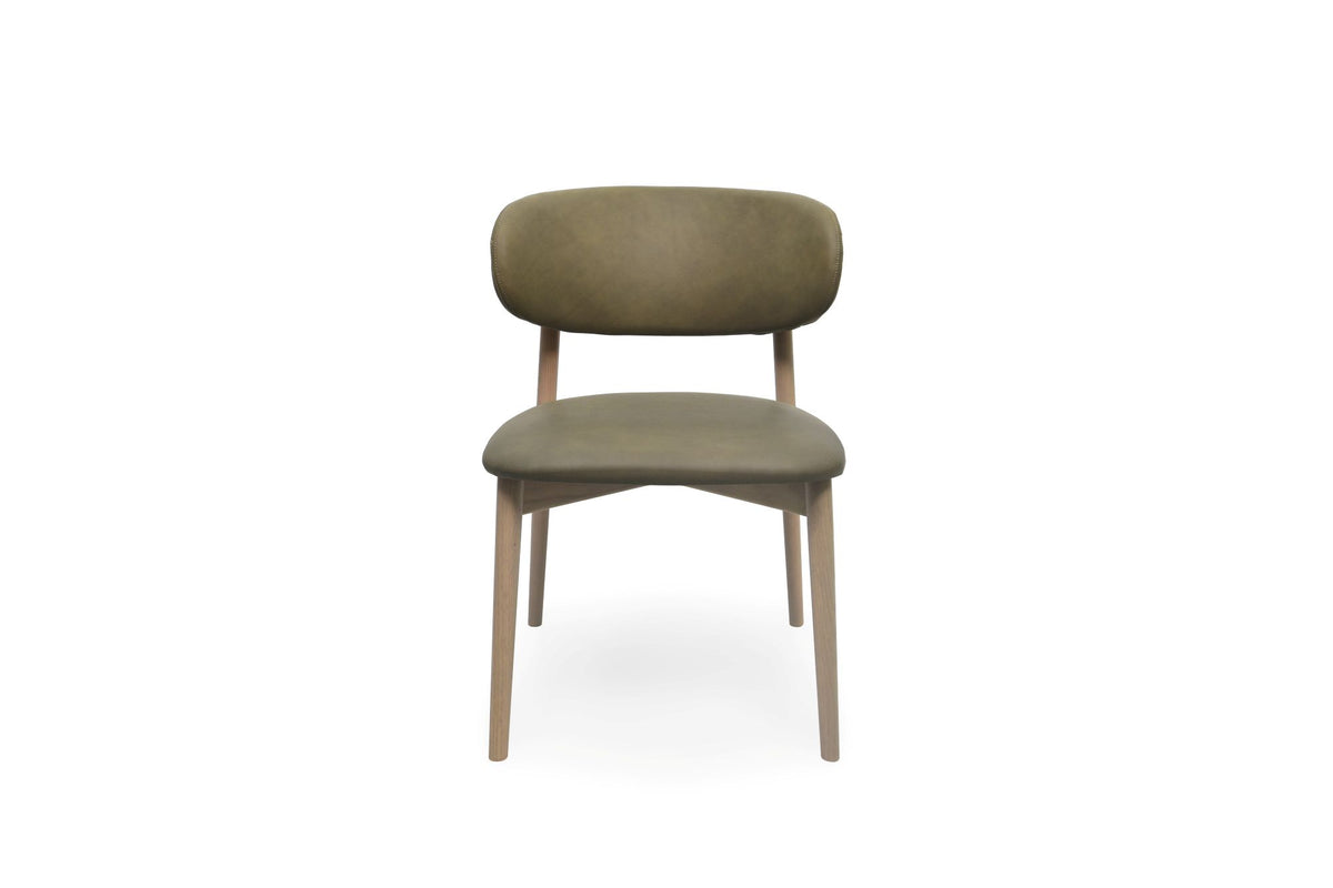 A modern dining chair with a rounded, cushioned backrest and seat upholstered in a muted olive green fabric, supported by light natural wood legs, shown against a plain white background.