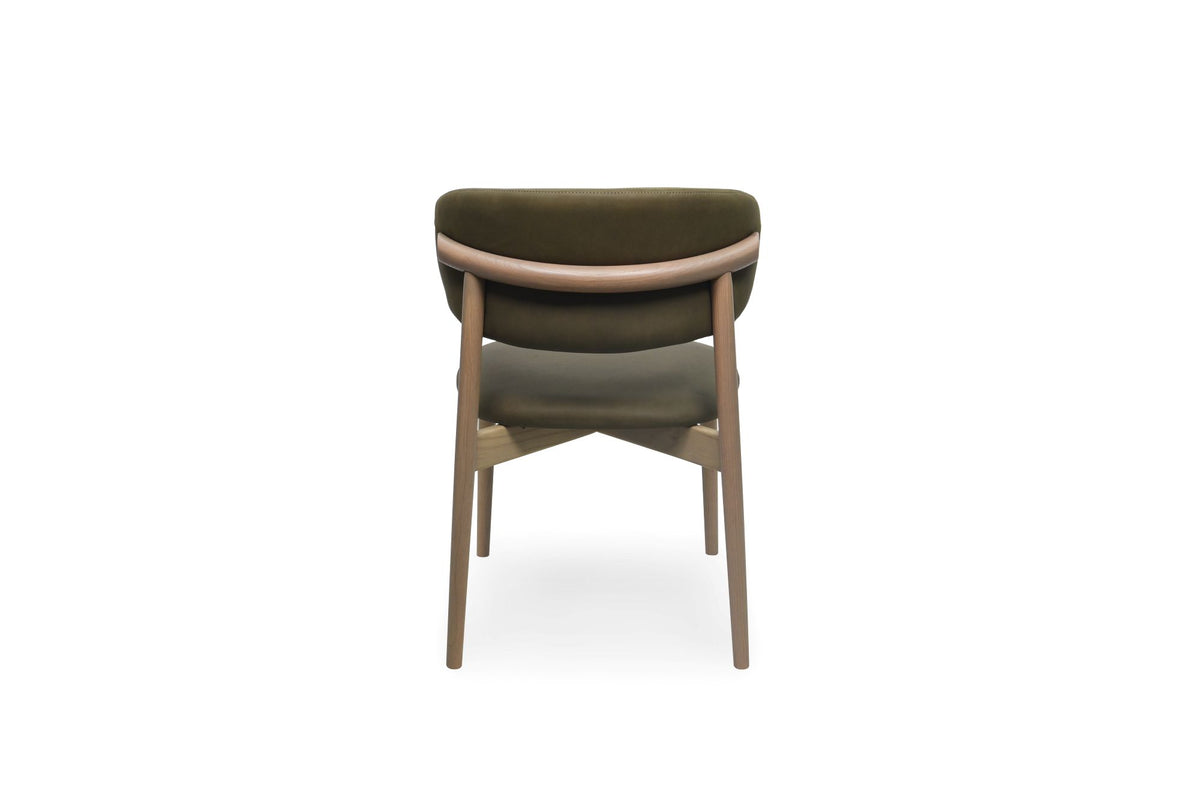 A modern dining chair with a curved olive green upholstered backrest and seat, supported by a light brown wooden frame, shown from the back against a white background.