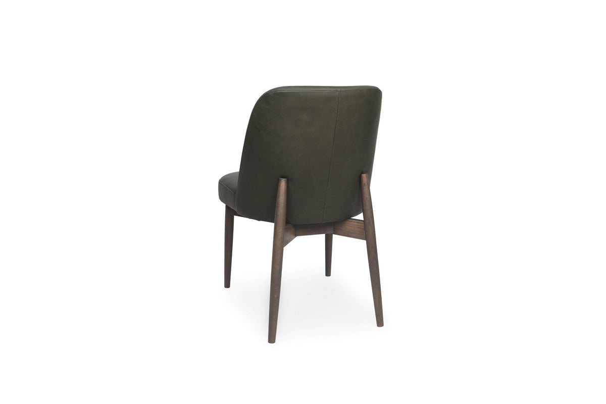 An upholstered dining chair shown from the back, featuring dark olive green fabric upholstery and a medium brown wooden frame with tapered legs, set against a plain white background.