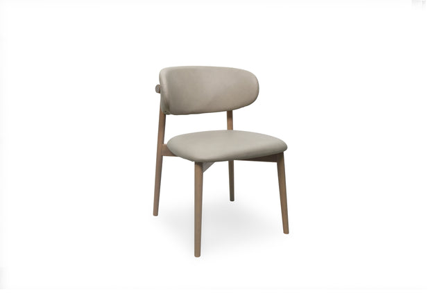 A modern dining chair with a light stone upholstered seat and curved backrest, supported by four tapered natural wood legs, shown against a plain white background.