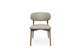 A modern upholstered dining chair with a curved backrest, upholstered in a light stone fabric, supported by a light oak wood frame, shown from the front on a white background.