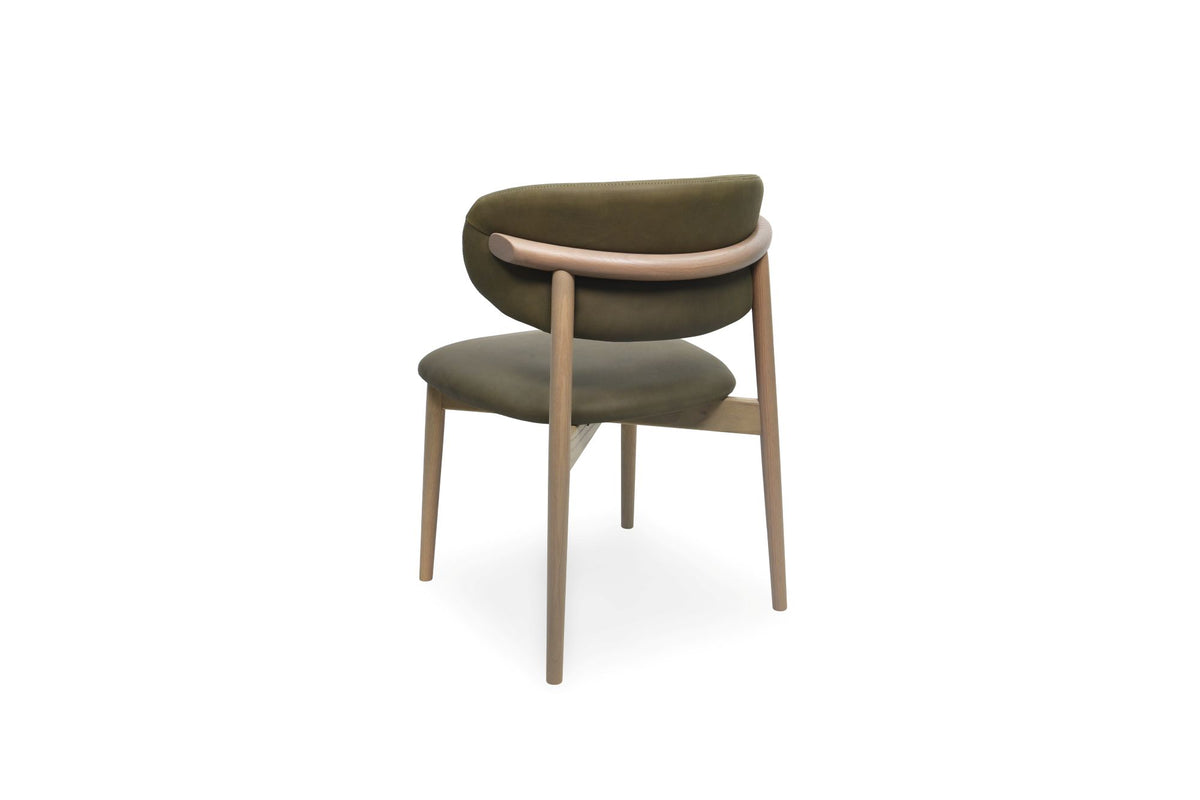 A modern dining chair with a curved olive green upholstered backrest and seat, supported by a light brown wooden frame, shown from the back against a white background.