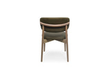 A modern dining chair with a curved olive green upholstered backrest and seat, supported by a light brown wooden frame, shown from the back against a white background.