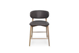 A modern counter stool with a dark chocolate upholstered seat and curved backrest, supported by four light natural wood legs with cross-bracing, shown against a plain white background.